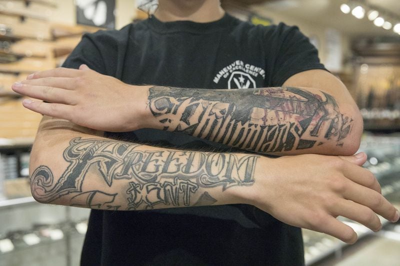 Dalton Peters, 20, shows off his tattoos. One says “Freedom Isn’t Free.” The other quotes from Philippians 4:13: “I can do all things” (through Christ who strengthens me). (ALYSSA POINTER/ALYSSA.POINTER@AJC.COM)
