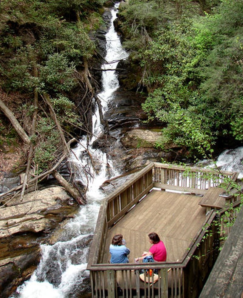 Lodge guests at Smithgall Woods State Park relax by Dukes Creek Falls. Lessie and Charles Smithgall owned the land and allowed Georgia to acquire it as a gift-purchase.
