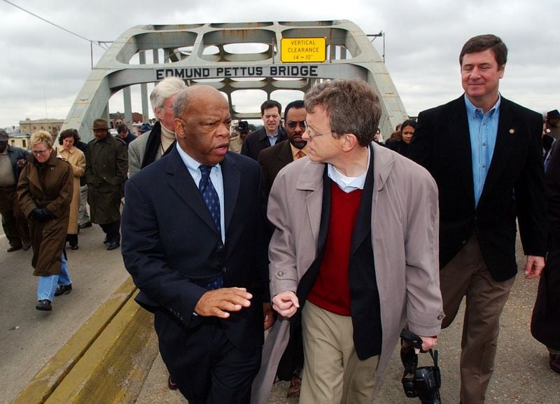 In this 2004 photo, U.S. Rep. John Lewis, D-Ga., is seen walking across the Edmund Pettus Bridge for an event in Selma, Ala. Lewis died in 2020 at age 80.