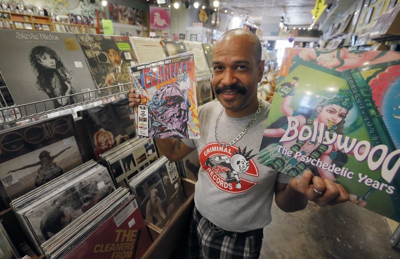 Caesar Ramirez shows some of the exclusive limited edition LPs that will be put out for Record Store Day. Local independent record store Criminal Records, located in Little Five Points, is one of more than 20 metro Atlanta businesses that will participate in the 10th annual Record Store Day on April 22. The event includes exclusive Record Store Day releases, raffles, live music and giveaways. BOB ANDRES / BANDRES@AJC.COM