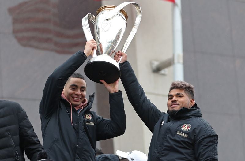December 10, 2018 - Atlanta, Ga: Atlanta United midfielder Miguel Almiron, left, and forward Josef Martinez hold up the MLS Cup as they ride a double decker bus during the victory rally, Monday, December 10, 2018, in Atlanta. The Atlanta United beat the Portland Timbers during the MLS Cup Championship that was hosted at Mercedes-Benz Stadium, Saturday, December 8.   (JASON GETZ/SPECIAL TO THE AJC)