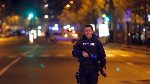 PARIS, FRANCE - NOVEMBER 13: A policeman patrols near the Boulevard des Filles-du-Calvaire after an attack November 13, 2015 in Paris, France. Gunfire and explosions in multiple locations erupted in the French capital with early casualty reports indicating at least 60 dead. (Photo by Thierry Chesnot/Getty Images)