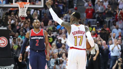 Atlanta Hawks Dennis Schroder encourages the crowd to cheer in the final minute of a 111-101 victory over the Washington Wizards with John Wall looking on in game 4 of a first-round NBA basketball playoff series on Monday, April 24, 2017, in Atlanta.