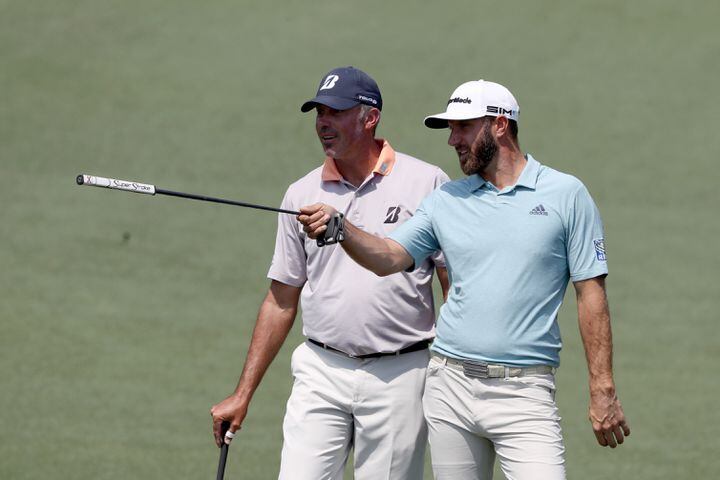 April 7, 2021, Augusta: Dustin Johnson, right, and Matt Kuchar look over a shot on the second hole during their practice round for the Masters at Augusta National Golf Club on Wednesday, April 7, 2021, in Augusta. Curtis Compton/ccompton@ajc.com