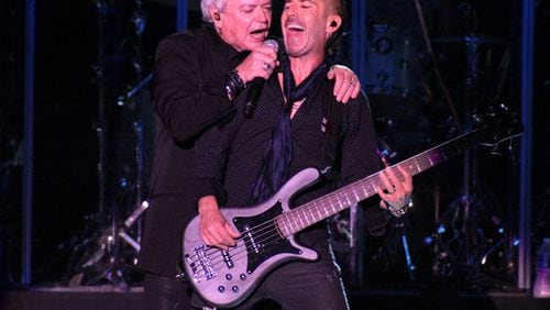 Air Supply's Russell Hitchcock and bassist Derek Frank share a moment during Friday's concert at Chastain. Photo: Melissa Ruggieri/AJC