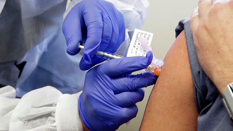 CDC Director Robert Redfield has told state governors to clear a regulatory path so that a coronavirus vaccine can be ready for distribution by Nov. 1. In this March photo, a subject receives a shot in the first-stage safety study clinical trial of a potential vaccine by Moderna. (AP Photo / Ted S. Warren)