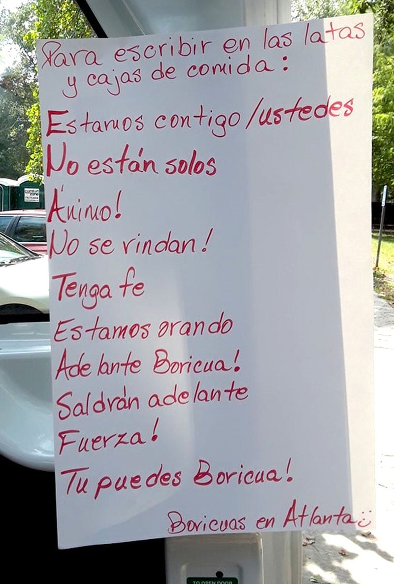 At an aid-collection station in metro Atlanta, a poster tells donors “to write on cans and boxes of food:” Estamos contigo / ustedes (We are with you); No estan solos (You are not alone); Animo! (Cheer up!); No se rindan! (Do not give up!); Tenga fe (Have faith); Estamos orando (We are praying); Adelante Boricua! (Go, Boricua!); Sadran adelante (You will prevail); Fuerza! (Be strong!); Tu puedes Boricua! (You can do it, Boricua!); (signed) Boricuans in Atlanta. (Photo by Mundo Hispanico)