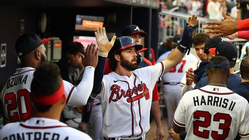 Braves shortstop Dansby Swanson gets high-fives in the dugout scoring on a RBI single by Austin Riley to take a 2-0 lead over the New York Mets during the third inning Thursday, August 18, 2022, in Atlanta.   “Curtis Compton / Curtis Compton@ajc.com