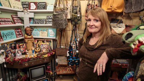 Owner Lori Ronca stands by a tribute to Mr. T. in her store HomeGrown Decatur on Small Business Saturday. STEVE SCHAEFER / SPECIAL TO THE AJC