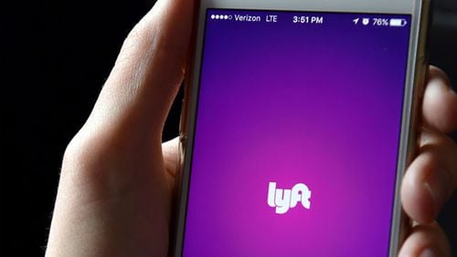 FILE PHOTO: The Lyft app is seen on a passenger's phone. (Photo by Mike Coppola/Getty Images for Lyft)