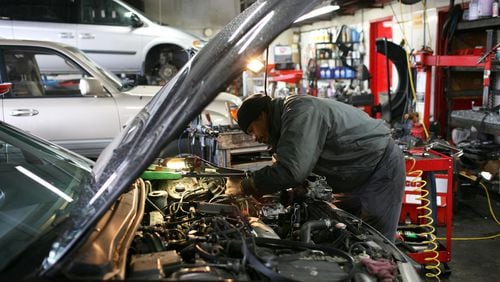 FILE PHOTO: A mechanic works on a car .
