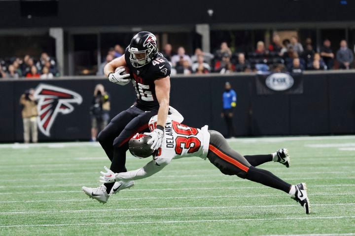 Falcons tight end Parker Hesse is tackled by Buccaneers cornerback Dee Delaney during the fourth quarter Sunday in Atlanta. (Miguel Martinez / miguel.martinezjimenez@ajc.com)
