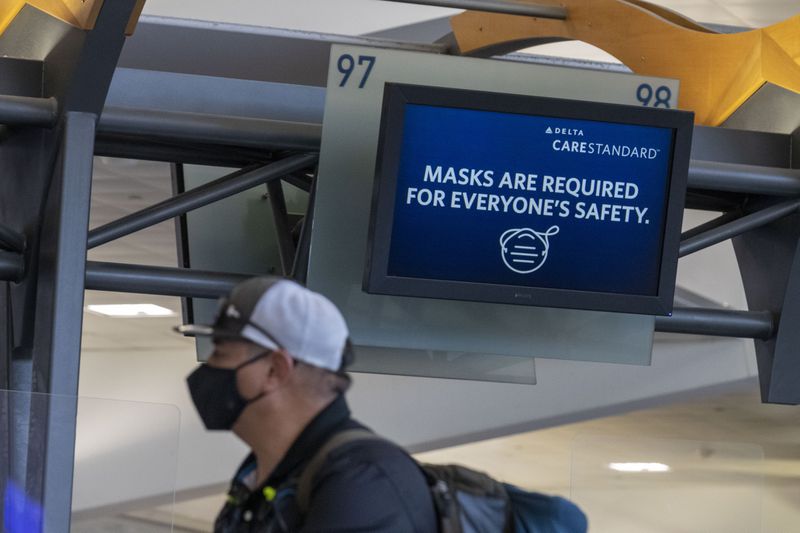 09/04/2020 -Atlanta, Georgia - Delta Air Lines customers wear masks as they wait to be served at the ticker counter in the domestic terminal at Hartsfield-Jackson Atlanta International Airport, Friday, September 4, 2020. (Alyssa Pointer / Alyssa.Pointer@ajc.com)
