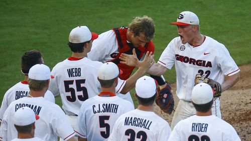 Georgia pitcher Aaron Schunk (22) celebrates with teammates after they defeated Arkansas 3-1 in a Southeastern Conference tournament NCAA college baseball game Thursday, May 23, 2019, in Hoover, Ala. (AP Photo/Butch Dill)