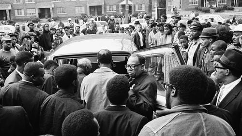 After a brief memorial service in Memphis on April 5, 1968, people stand around the Cadillac hearse that would carry the body of Martin Luther King Jr. to the airport. (AP photo)
