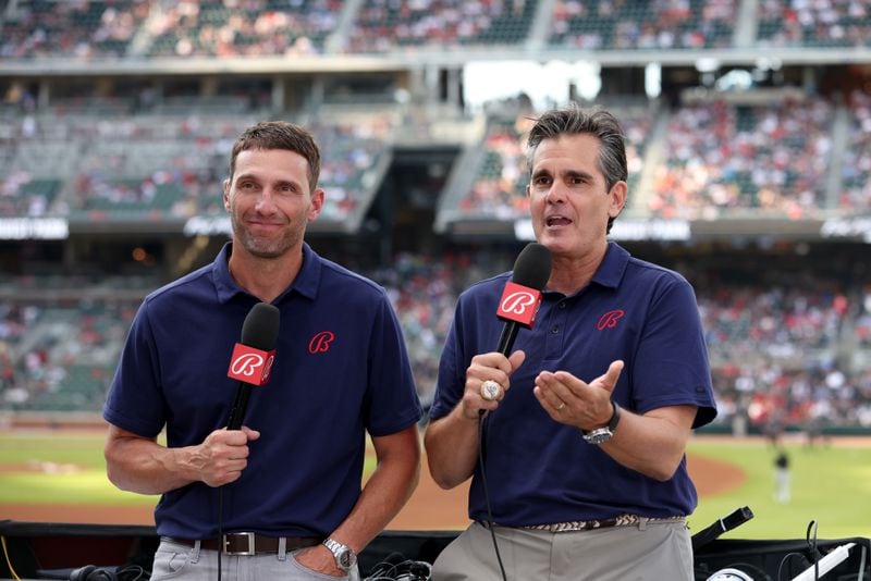 Jeff Francoeur, left, and Chip Caray broadcast the Atlanta Braves vs Miami Marlins game from the right field stands in front of the Coors Light Chop House at Truist Park Friday, May 27, 2022, in Atlanta.  (Jason Getz / Jason.Getz@ajc.com)
