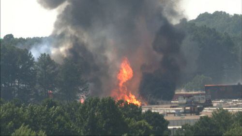 A massive fire sent a plume of smoke into the air near the Atlanta airport Friday afternoon.