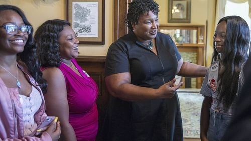 Georgia Democratic gubernatorial candidate Stacey Abrams (center) has a one-on-one conversation with a group of women after holding a roundtable discussion in August at the Valdosta-Lowndes Chamber of Commerce. ALYSSA POINTER/ALYSSA.POINTER@AJC.COM)