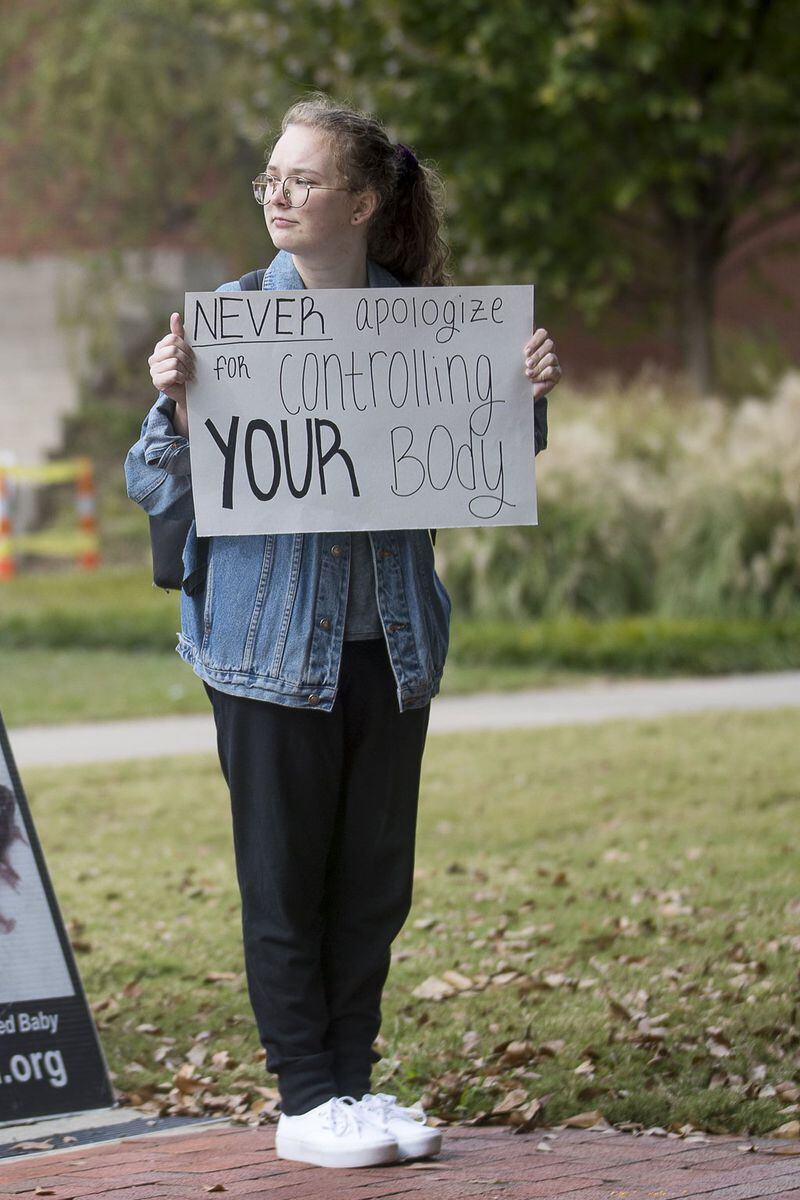 Georgia Tech student Brooke McKenzie, 19, holds a pro-choice sign during a Created Equal event on campus in Atlanta on Monday. The Created Equal organization visited the campus with large photographs and video of aborted fetuses. 