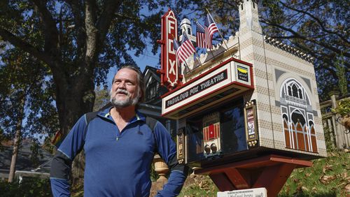 Rick Schroeder stands next to the replica of The Fox Theatre that he built as a free library in front of his home on Thursday, November 3, 2022. (Natrice Miller/natrice.miller@ajc.com)  