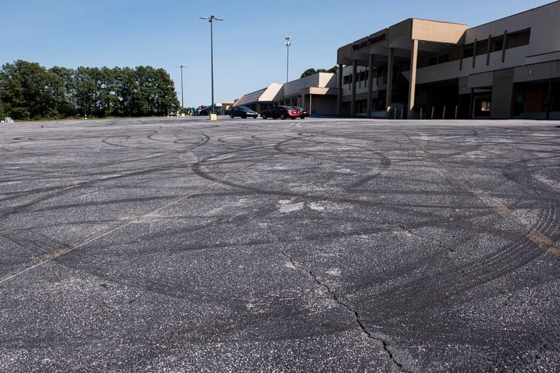 201001-Stone Mountain-Tire marks from cars doing burnouts cover the parking lot of the mostly vacant Village Square shopping center on Memorial Drive in Stone Mountain. Ben Gray for the Atlanta Journal-Constitution