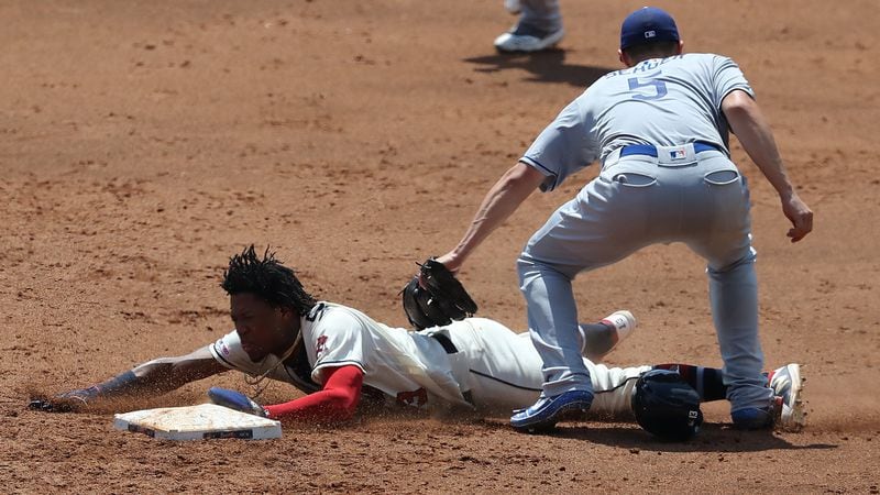 Braves outfielder Ronald Acuna is tagged out by Los Angeles Dodgers' Corey Seager as he attempted to steal second base in the third inning Sunday, Aug. 18, 2019, at SunTrust Park in Atlanta. Acuna was removed by manager Brian Snitker after the play.