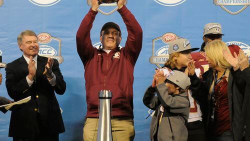 Florida State head coach Jimbo Fisher celebrates with the trophy after winning the Atlantic Coast Conference championship NCAA college football game against Georgia Tech in Charlotte, N.C., Saturday, Dec. 6, 2014. Florida State won 37-35. (AP Photo/Mike McCarn) Think Jimbo Fisher is still upset about Georgia hiring his defensive coordinator, Jeremy Pruitt? (AP photo)