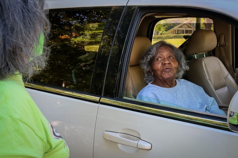 Sophie Lillian Carey, 103, grew up near Rose Hill and attended the Antioch East Baptist Church. She watched as volunteers celebrated her old neighborhood. (Arvin Temkar / arvin.temkar@ajc.com)