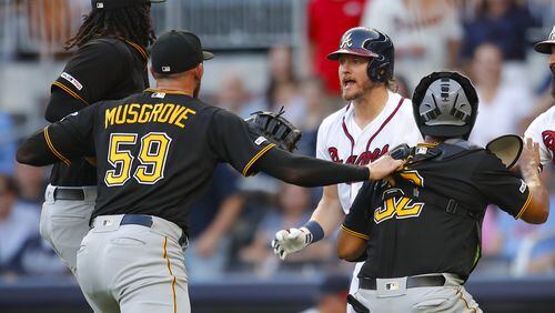 Braves Josh Donaldson and Pittsburgh pitcher Joe Musgrove exchange unpleasantries Monday night. (Photo by Todd Kirkland/Getty Images)
