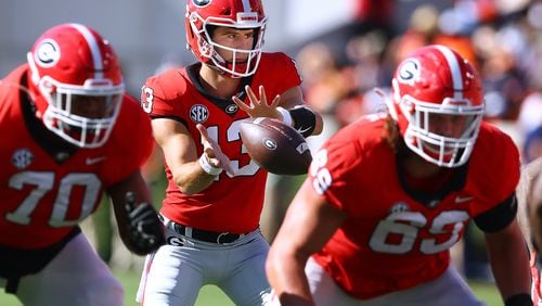Georgia QB Stetson Bennett and the offensive line will likely face a strong challenge from LSU defensive lineman Harold Perkins Jr. in Saturday's SEC Championship game. (AJC file photo)