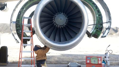 In this photo Tuesday, Dec. 10, 2013, photo, parts are removed from a retired American Airlines' jet engine in Roswell, New Mexico. (AP Photo/LM Otero)