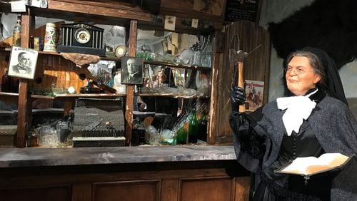At the American Prohibition Museum in Savannah, a wax figure of Temperance Movement leader Carry A. Nation stands next to a bar smashed with an ax. Photo by Ligaya Figueras.