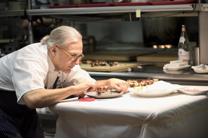 Kyma executive chef Pano I. Karatassos puts the finishing touches on one of the dishes being photographed for his new cookbook, which is due to be released in the winter of 2018. CONTRIBUTED BY GALINA JULIANA