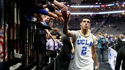 UCLA Bruins guard Lonzo Ball slaps hands as he walks to the locker room after UCLA beat Cincinnati 79-67 in a second-round game of the men’s NCAA college basketball tournament in Sacramento, Calif., on Sunday, March 19, 2017. (AP Photo/Rich Pedroncelli)