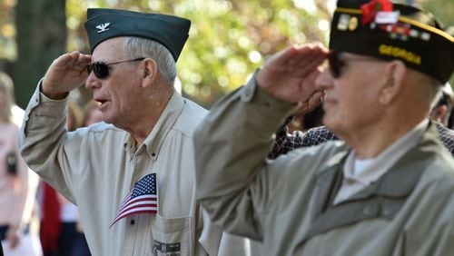 FILE PHOTO: Veterans Reuel Hamilton, left, and Robert Bukofske salute the flag during a ceremony at the conclusion of the annual Marietta Veterans Day Parade in Marietta. BRANT SANDERLIN/BSANDERLIN@AJC.COM