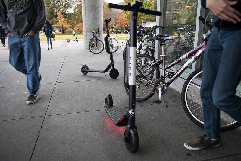 Students walk around Bird scooters near the bicycle rack at Georgia Tech's campus in Atlanta. (Photo: ALYSSA POINTER / ALYSSA.POINTER@AJC.COM)