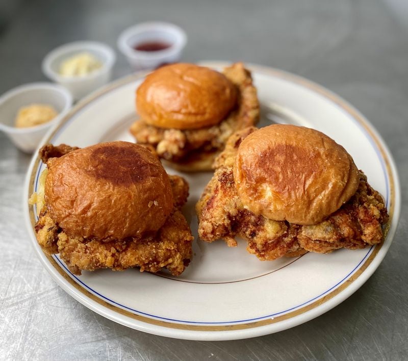 How Crispy makes breakfast sandwiches, like the French toast-dipped Early Bird Deluxx (front two) and the Early Bird (rear). Both come with whipped honey butter. Wendell Brock for The Atlanta Journal-Constitution