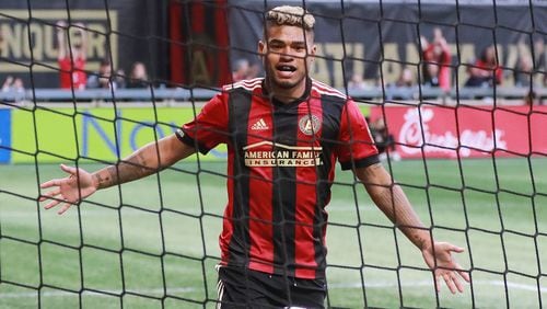 Atlanta United forward Josef Martinez celebrates a goal by teammate Chris McCann for a 2-1 lead over the Chicago Fire during the first half in a MLS soccer match on Sunday, Oct 21, 2018, in Atlanta. Atlanta United clinched a playoff spot with a 2-1 victory.  Curtis Compton/ccompton@ajc.com
