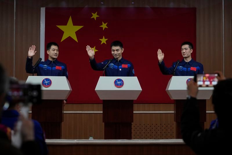 Chinese astronauts for the upcoming Shenzhou-18 mission, from left, Li Guangsu, Ye Guangfu and Li Cong, wave as they arrive for a meeting with media members at the Jiuquan Satellite Launch Center in northwest China, Wednesday, April 24, 2024. (AP Photo/Andy Wong)