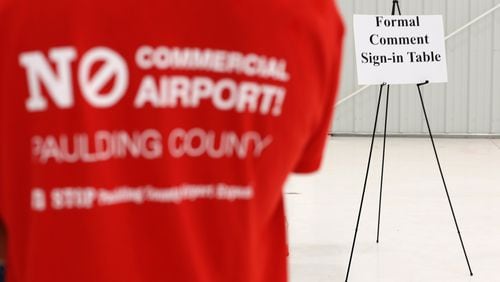 An opponent of commercializing the airport in Paulding County waits in line to sign up to speak at a December hearing. Ben Gray / bgray@ajc.com
