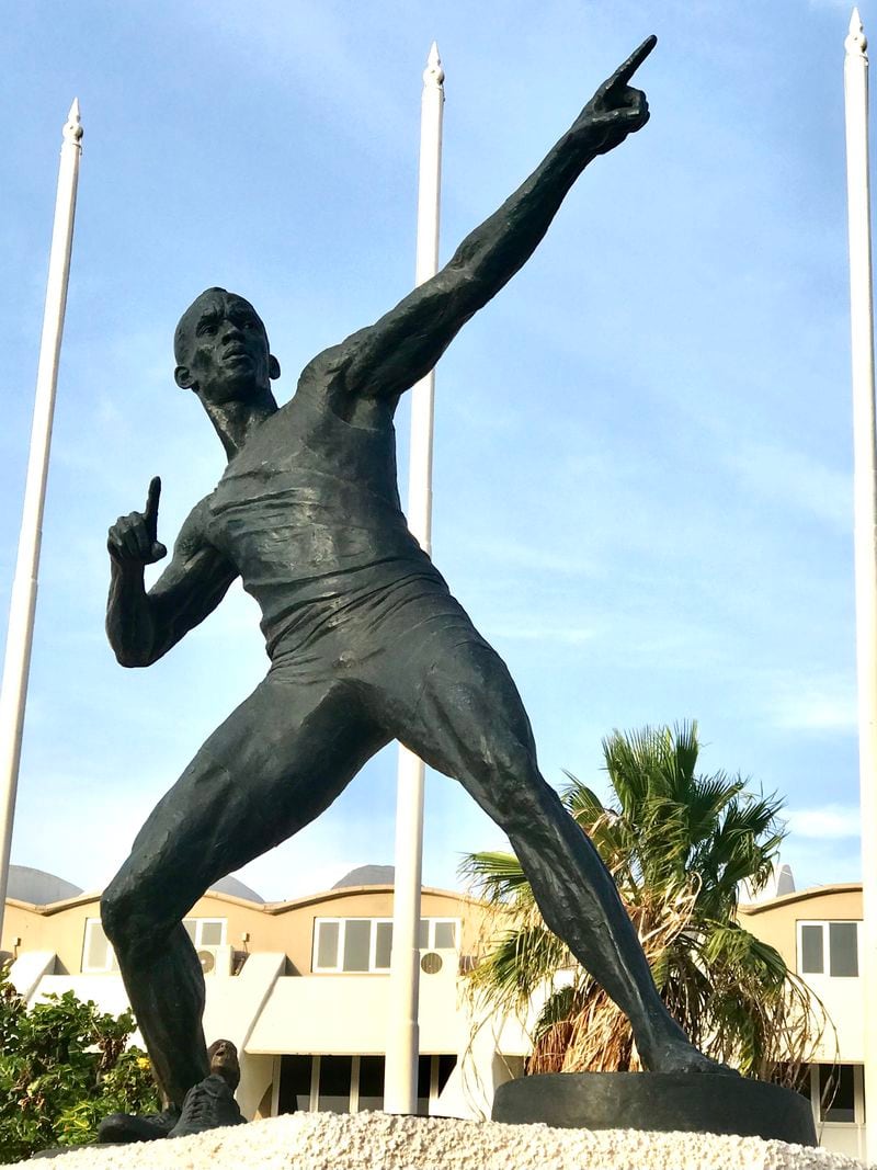 Basil Watson's larger-than-life-size sculptures of Olympic gold medalists Usain Bolt, Shelly-Ann Fraser-Pryce and Asafa Powell surround Jamaica’s National Stadium.