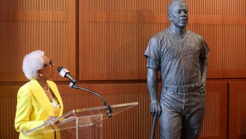 Billye Aaron, Hank Aaron’s widow, looks at the statue as she speaks during the unveiling of the Hank Aaron statue by the grand staircase at the National Baseball Hall of Fame, Thursday, May 23, 2024, in Cooperstown, NY. (Jason Getz / AJC)
