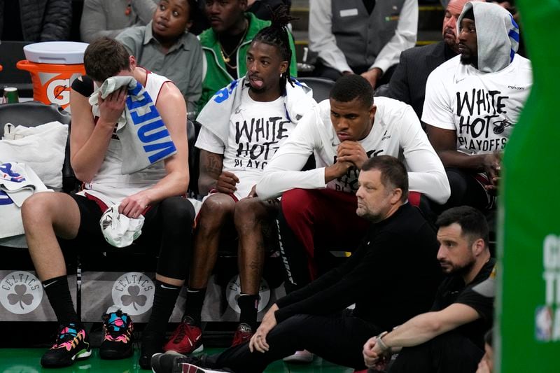 Miami Heat players watch from the bench while trailing the Boston Celtics by more than 30 points during the second half of Game 5 of an NBA basketball first-round playoff series, Wednesday, May 1, 2024, in Boston. (AP Photo/Charles Krupa)