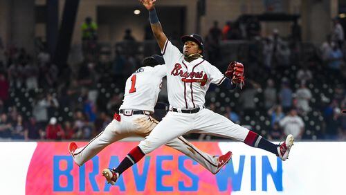 Ronald Acuna Jr. #13 and Ozzie Albies #1 of the Atlanta Braves celebrate an 11-7 win over the New York Mets  at SunTrust Park on April 13, 2019 in Atlanta, Georgia. (Photo by John Amis/Getty Images)