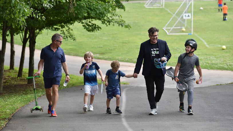 This will be the first Father’s Day that they’re officially a family: Matthew Simon and Keith Schumann walk with their sons Hunter, 6, Owen, 4, and Jackson, 10, after soccer practice. HYOSUB SHIN / HSHIN@AJC.COM