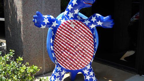 A painted turtle stands guard at the entrance of the Sandy Springs City Council chamber. The Council recently approved grants totaling $50,000 for 11 local nonprofits. AJC FILE