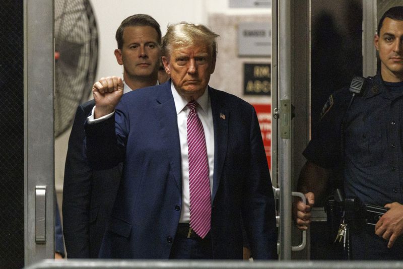 Former President Donald Trump gestures as he returns to the courtroom following a break in his trial, Friday, April 19, 2024, at Manhattan Criminal Court in New York. (Sarah Yenesel/Pool Photo via AP)