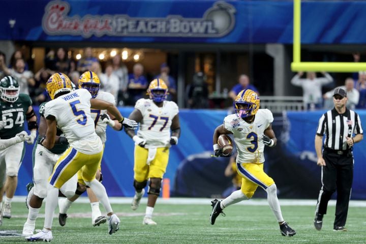 Pittsburgh Panthers wide receiver Jordan Addison (3) runs after a catch for a 52-yard gain during the first half against the Michigan State Spartans in the Chick-fil-A Peach Bowl at Mercedes-Benz Stadium in Atlanta, Thursday, December 30, 2021. JASON GETZ FOR THE ATLANTA JOURNAL-CONSTITUTION