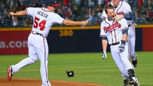Kris Medlen, shown here squirting water on Freddie Freeman after a win last August, has always been one of the team's free spirits. (Curtis Compton/AJC)