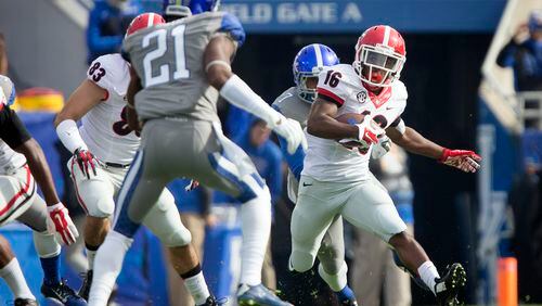 Georgia wide receiver Isaiah McKenzie, right, returns a kickoff for a touchdown during the first half of an NCAA college football game against Kentucky at Commonwealth Stadium in Lexington, Ky., Saturday, Nov. 8, 2014. (AP Photo/David Stephenson)